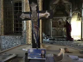 A crucifix survived the damage done to St. George Syriac Catholic Church in the Christian town of Bartella in Iraq. Islamic State in Iraq and the Levant singled churches out for destruction during the 27 months they occupied much of Iraq's Ninenveh Plain.