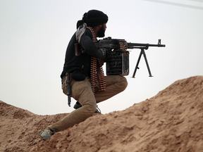 A Shiite fighter fires toward ISIL positions on the outskirts of Mosul, Dec. 13, 2016.