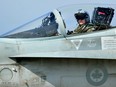 A Canadian F18 jet pilot from the 425 Tactical Fighter squadron from 3 Wing Bagotville Quebec, sits in his plane upon arrival from a mission on March 25, 2011 at Trapani-Birgi airbase in Sicily.