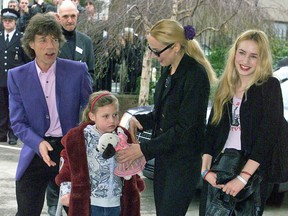 Mick Jagger arrives at his old school on March 20, 2000, in London with his former wife Jerry, second from right, and children, Elizabeth, right, and Georgia, at front.