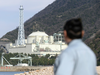 A resident looks at fast-breeder reactor Monju in Tsuruga, Fukui prefecture, on the Sea of Japan coast Wednesday, Dec. 21, 2016.