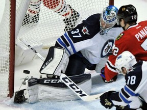 Winnipeg Jets' goaltender Connor Hellebuyck makes a save against the Chicago Blackhawks during NHL action Tuesday night in Chicago. The Jets were 3-1 winners.