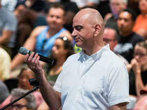 Joe Clark reacts after his microphone is turned off at a Pride Toronto event in August.