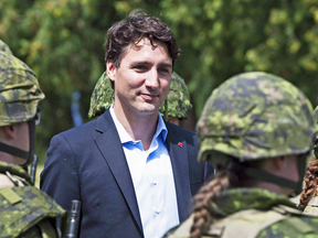 Prime Minister Justin Trudeau reviews an honour guard as they arrive at the International Peacekeeping and Security Centre in Yavoriv, Ukraine, July 12, 2016.