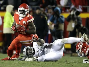 Tyreek Hill of the Kansas City Chiefs breaks the attempted tackle of Oakland Raiders' Perry Riley during the Thursday night NFL game in Kansas City. Hill had a pair of touchdowns in leading the Chiefs to a 21-13 victory, improving to 10-3 on the season.