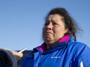 Kristen Ireland, who lost a brother and four of his children to a fire Wednesday, talks to reporters outside of the Oneida Council Office on the Oneida settlement, south west of London, Ont. on Thursday.