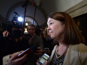Minister of Health Jane Philpott listens to a reporter's question as she leaves a caucus meeting on Parliament Hill in Ottawa on Wednesday, Dec 14, 2016