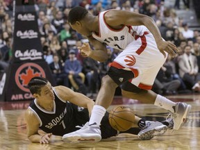 Kyle Lowry, right, of the Toronto Raptors battles for a loose ball with Brooklyn Nets' Jeremy Lin during NBA action Tuesday night at the Air Canada Centre. Lowry had 23 points as the Raptors ended the 2016 portion of their home schedule with a 116-104 victory.