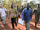 In this photo taken Friday, Jan. 16, 2015 and released by the Uganda People's Defence Force (UPDF), a man said by the UPDF to be the wanted Lord's Resistance Army (LRA) commander Dominic Ongwen, center-right, is handed over by the UPDF to the African Union Regional Task Force who later handed him over to Central African Republic authorities, in the Central African Republic.