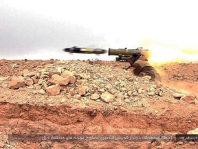 This image posted online on Saturday, Dec. 10, 2016, by supporters of ISIL  purports to show a gunman firing an anti-tank missile at Syrian troops north of Palmyra