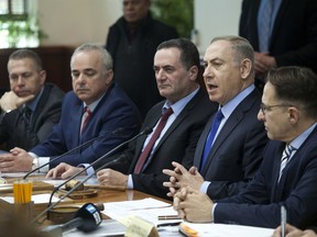 Israeli Prime Minister Benjamin Netanyahu, second right, attends a weekly cabinet meeting in Jerusalem, Sunday, Dec. 25.