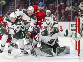 Minnesota Wild goaltender Devan Dubynk has to contend with Montreal Canadiens' forward Alexander Radulov wreaking havoc in front of his goal during Thursday night NHL action in Montreal.  Providing defence for Dubnyk are Mikko Koivu, left, and Ryan Suter. Minnesota won its ninth straight game, 4-2 over the Canadiens.