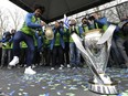 Seattle Sounders defender Roman Torres, left, dances on stage for teammates next to the MLS Cup trophy during a fan rally, Tuesday, Dec. 13, 2016, in Seattle. The Sounders defeated Toronto FC on Dec. 10, 2016 to win the MLS soccer championship. (AP Photo/Ted S. Warren)