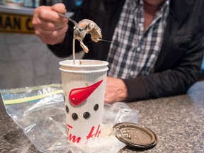 Jim Elliott displays the mouse he claims he found in a coffee he purchased at a Tim Hortons outlet, at his residence in Stewiacke, N.S., on Friday, Dec. 9, 2016.