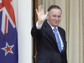 New Zealand's Prime Minister John Key waves to media on Oct. 26, 2016. He stunned the nation on Monday, Dec. 5 when he announced he was resigning after eight years as leader.