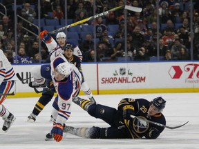Sabres defenceman Jake McCabe trips up Edmonton Oilers forward Connor McDavid during the second period of their game on Tuesday night in Buffalo, N.Y.