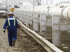 A worker walks along a pipeline at the Enbridge facility in the east of Edmonton.
