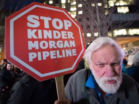 Paul George holds a sign during a protest against the Kinder Morgan Trans Mountain Pipeline expansion project, in Vancouver, B.C., on Tuesday Nov. 29, 2016.