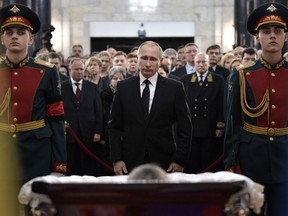 Russian President Vladimir Putin pays his respects to slain Russian Ambassador to Turkey Andrei Karlov, during the funeral ceremony at the Russian Foreign Ministry in Moscow on Dec. 22, 2016.