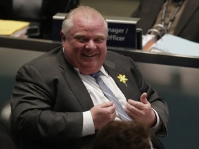 Mayor Rob Ford  laughing during  voting on  food trucks in Toronto, Ont. on Thursday April 3, 2014.