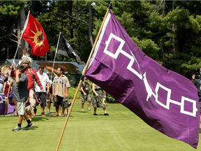 Kanesatake Mohawks display the Five Nations flag at the Club de Golf Oka in 2015, marking an anniversary of the Oka Crisis.
