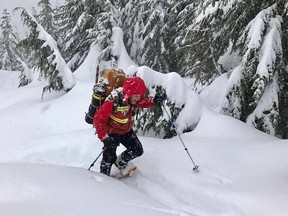 A North Shore Rescue member searches on the trails surrounding Cypress Mountain for two missing hikers on Monday, December 26, 2016