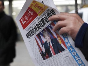 A Nov. 10, 2016 file photo of a newspaper in China with the headline that reads 'U.S. President-elect Donald Trump delivers a mighty shock to America'