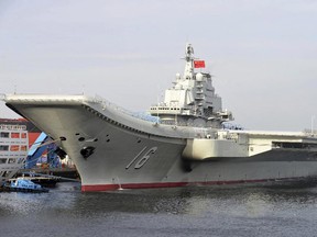 In this undated file photo released by China's Xinhua News Agency, China's aircraft carrier Liaoning berths in a port of China