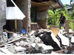 In this photo provided by World Vision Solomon Islands, a house in Kirakira, Solomon Islands, is damaged after an earthquake on Friday, Dec. 9, 2016