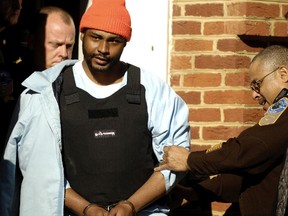 In this 2007 file photo, Ricky Gray is escorted from the county courthouse in Culpeper, Va., following his preliminary hearing. Gray asked a federal court Wednesday, Dec. 14, 2016, to block the state's plans to execute him next month with lethal injection drugs from a secret compounding pharmacy, suggesting even a firing squad would be more humane.