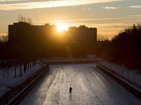 A lone skater heads down the Rideau Canal Skateway near Somerset Street in Ottawa at sunrise