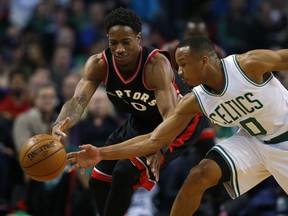 Boston Celtics guard Avery Bradley knocks the ball from Toronto Raptors' DeMar DeRozan during NBA action Friday night in Boston. The Raptors spotted the Celtics a 14-point lead before winning, 101-94.