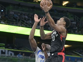 Toronto Raptors guard DeMar DeRozan goes up for a shot in front of Orlando Magic centre Bismack Biyombo in Orlando on Sunday. The Raptors 109-79.