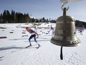 In this Sunday, Feb. 23, 2014 file photo, athletes pass by the bell during the men's 50K cross-country race at the 2014 Winter Olympics in Krasnaya Polyana, Russia