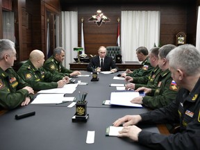 Russian President Vladimir Putin, center, meets with senior military officials in Moscow, Russia on Thursday, Dec. 22, 2016.