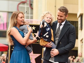 Blake Lively and Ryan Reynolds pose with their daughters on the Hollywood Walk of Fame on December 15, 2016 in Hollywood, California.