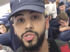 A still from Saleh's video on the plane as he was being escorted off.