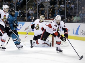 Ottawa Senators captain Erik Karlsson controls the puck in front of goaltender Mike Condon during their game Wednesday night against the Sharks in San Jose, Calif. The Senators won 4-2.