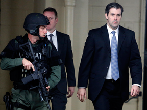 Michael Slager, right, walks from a courthouse under the protection from the Charleston County Sheriff's Department after a mistrial was declared for his trial Monday Dec. 5, 2016, in Charleston, S.C. Slager, was charged with murder in the April 4, 2015, shooting death of 50-year-old Walter Scott.