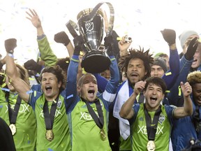 Members of the Seattle Sounders celebrate after winning the MLS Cup in a penalty shootout over Toronto FC at BMO Field in Toronto on Saturday night.