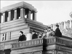 Top Soviet officials standing at the balcony of the Lenin Mausoleum (from left) V. Kuybyshev, Mikhail Ivanovich Kalinin, Joseph Stalin, Grigori Konstantionovitch Ordjonikidze and Felix Kon, review a military parade in 1926.