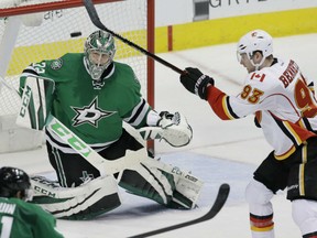Sam Bennett of the Calgary Flames tries to get his stick on the puck in front of Dallas Stars' goaltender Antti Niemi during NHL action Tuesday night in Dallas. The Flames made it four straight wins with a 2-1 victory.