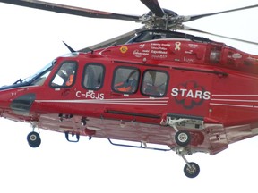 A STARS helicopter eventually rescued a pair of best friends stuck in the Alberta woods after one of them was injured in a car crash.