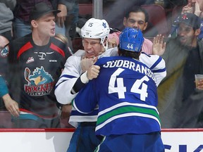 Vancouver Canucks defenceman Erik Gudbranson (right) fights Toronto Maple Leafs forward Matt Martin on Dec. 3.