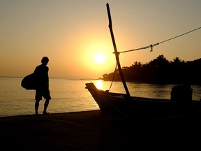 A surfer sets of for a dawn start at Main Point, one of Arugam Bay's most famous surf-breaks in Sri Lanka.