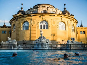 Visitors swim in an outdoor pool of Szechenyi Thermal Bath and Swimming Pool in Budapest, Hungary.