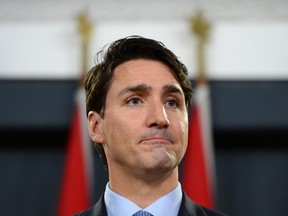 Prime Minister Justin Trudeau leaves after holding a press conference at the National Press Theatre in Ottawa on Monday, Dec. 12, 2016