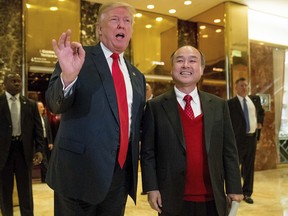 President-elect Donald Trump, accompanied by SoftBank CEO Masayoshi Son, speaks to members of the media at Trump Tower in New York, Tuesday, Dec. 6, 2016. (AP Photo/Andrew Harnik) ORG XMIT: NYAH136