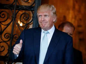 President-elect Donald Trump gives a thumbs up to reporters at Mar-a-Lago, Wednesday, Dec. 28, 2016, in Palm Beach, Fla.