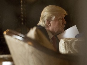 President-elect Donald Trump attends a meeting at Mar-a-Lago, in Palm Beach, Fla. Trump is moving to separate himself from his business and his charity to avoid conflict of interest in the Oval Office.